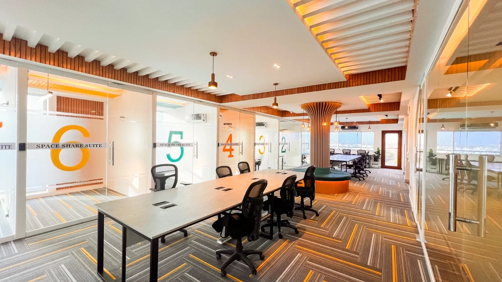 An open-plan coworking floor with people working at shared desks