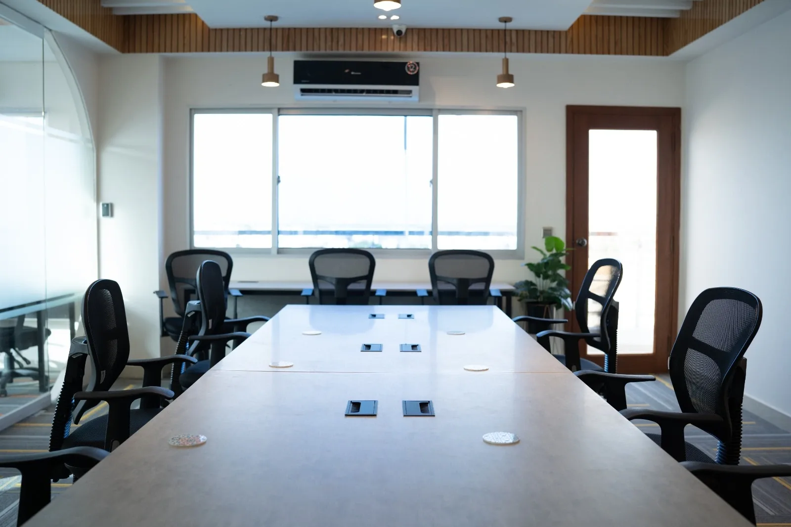 A SpaceShare meeting room with a boardroom table and a display screen
